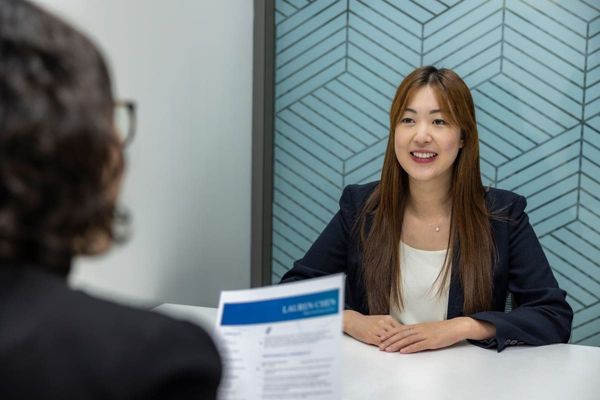A candidate smiling across the interview table